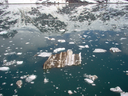 ...carrying the debris of its passage over the rock